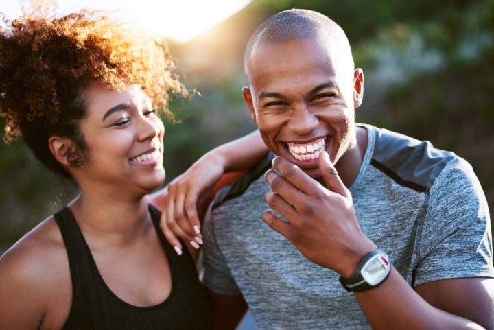 woman and man smiling at the camera