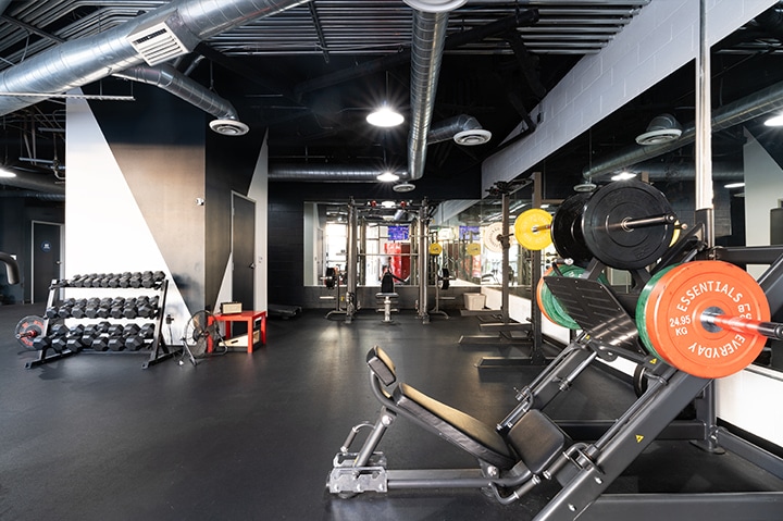 gym with stationary bicycles, squat rack, weights, and other gym equipment